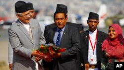 FILE - Maldives President Abdullah Yameen, center, is welcomed at Tribhuwan Airport to attend the South Asian Association for Regional Cooperation summit in Katmandu, Nepal, Nov. 25, 2014.
