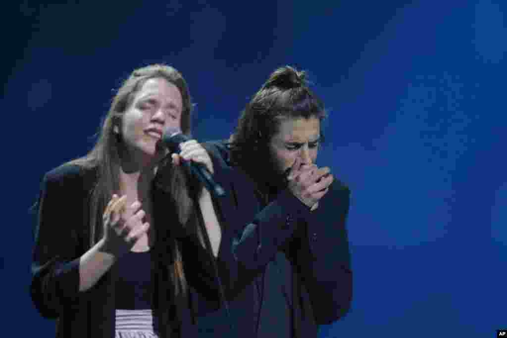 Salvador Sobral from Portugal, right, performs the song "Amar pelos dois" with his sister Luisa after winning the Final of the Eurovision Song Contest, in Kyiv, Ukraine, May 13, 2017.