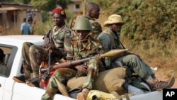 Seleka militias drive through Bangui, Central African Republic, Jan. 27, 2014, after evacuating Camp Deroux. 