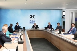 G-7 summit participants are seen during a session in Cornwall, England, June 12, 2021, with summit host, Britain's Prime Minister Boris Johnson, presiding.