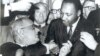 U.S. President Lyndon Johnson, left, and civil rights leader Martin Luther King Jr. shake hands at the Voting Rights Act's signing in the Capitol, Washington, August 6, 1965. (Creative Commons)