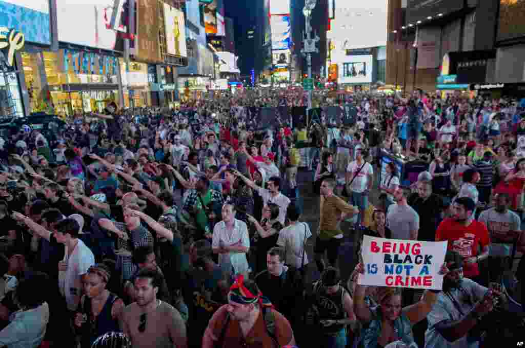 Throngs of marches gather in Times Square to protest the acquittal of George Zimmerman, New York, July 14, 2013.