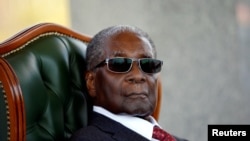 FILE - Zimbabwe's former president Robert Mugabe looks on during a press conference at his private residence nicknamed "Blue Roof" in Harare, Zimbabwe, July 29, 2018.