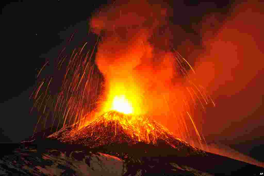 Mt. Etna, Europe's most active volcano, spews lava during an eruption as seen from Acireale, near the Sicilian town of Catania, Italy, Nov. 16, 2013.