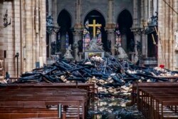 FILE - A hole is seen in the dome inside Notre Dame cathedral in Paris, France, April 16, 2019.