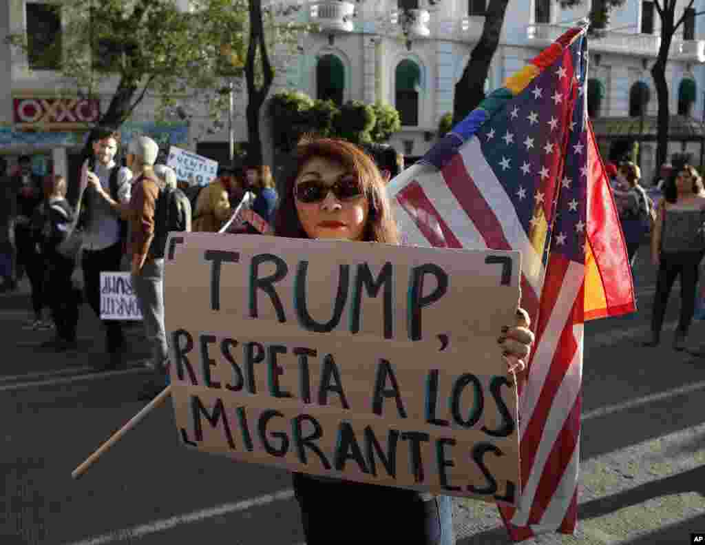 A woman holds a sign that reads in Spanish "Trump, respect migrants" during a march called by a local women's movement against U.S. President Donald Trump in Mexico City, Friday, Jan. 20, 2017. Donald Trump became the 45th president of the United States Friday, Jan. 20 2017, amid apprehension in Mexico regarding his previous comments about Mexico and his promise to build a border wall to halt migration. (AP Photo/Eduardo Verdugo)