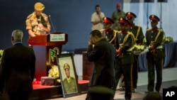 Ethiopia's Prime Minister Abiy Ahmed, center, attends a state ceremony for assassinated army chief Gen. Seare Mekonnen, at the Millennium Hall in the capital Addis Ababa, Ethiopia, June 25, 2019. 
