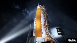 This illustration shows NASA’s new rocket, the Space Launch System (SLS), in its Block 1 crew vehicle setup that will send astronauts to the Moon on the Artemis missions. 