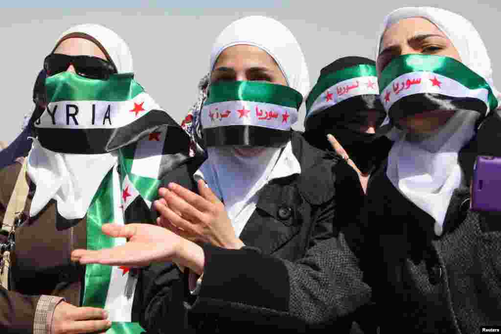 Syrians living in Jordan take part in a protest against Syria's President Bashar al-Assad in front of the Syrian embassy in Amman, March 29, 2013.