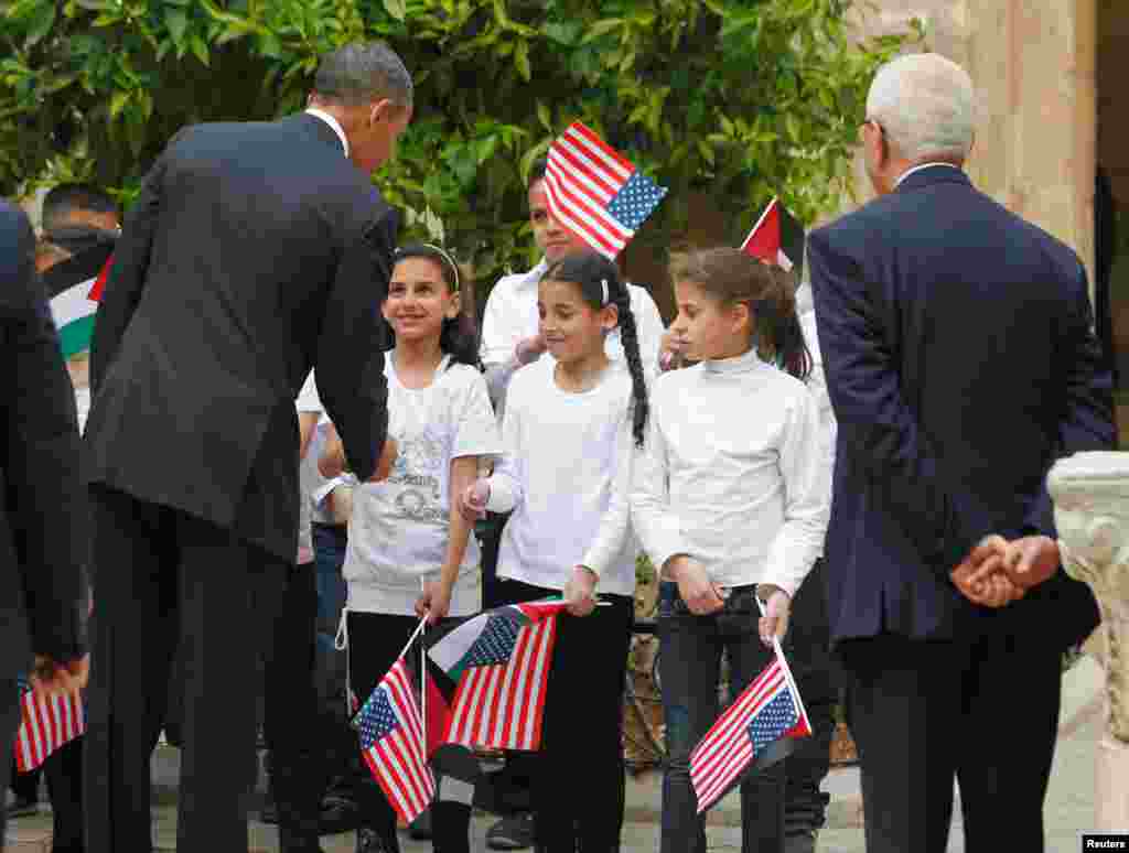 Obama interacts with children as he tours the Church of the Nativity in Bethlehem, March 22, 2013.