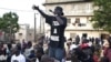 A member of the activist hip-hop group Y'en a marre performs during a community concert in the Dalifort neighborhood of Senegal's capital Dakar. Using a mix of concerts, demonstrations and stomping the streets in black T-shirts emblazoned with their name