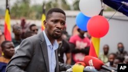 FILE - Ugandan opposition figure Bobi Wine, whose real name is Kyagulanyi Ssentamu, speaks at a press conference in Kampala, Uganda, Feb. 22, 2021.