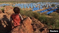 FILE - A boy sits atop a hill overlooking a refugee camp near the Chad-Sudan border on Nov. 9, 2023. A U.N. report released March 1, 2024, says the ongoing conflict in Sudan has resulted in the displacement of 8.1 million people.