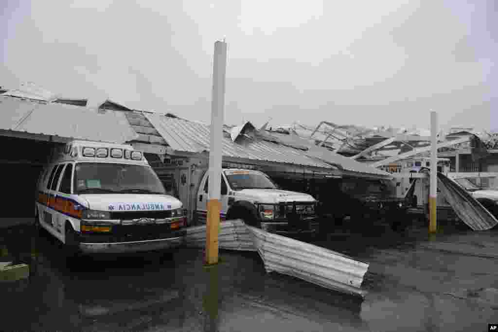 Rescue vehicles from the Emergency Management Agency stand trapped under an awning during the impact of Hurricane Maria, which hit the eastern region of the island, in Humacao, Puerto Rico, Sept. 20, 2017.