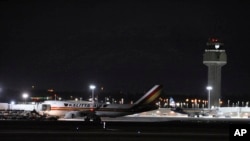 Carrying some 240 American diplomats and citizens, a Boeing 747 aircraft sits on the tarmac of Ted Stevens Anchorage International Airport in Anchorage, Alaska, Jan. 28, 2020. 