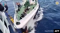 This frame grab from handout video footage taken and released on Aug. 25, 2024 by the Philippine coast guard shows a Chinese ship in a collision with a Philippine Bureau of Fisheries and Aquatic Resources vessel near Sabina Shoal in disputed waters of the South China Sea. 