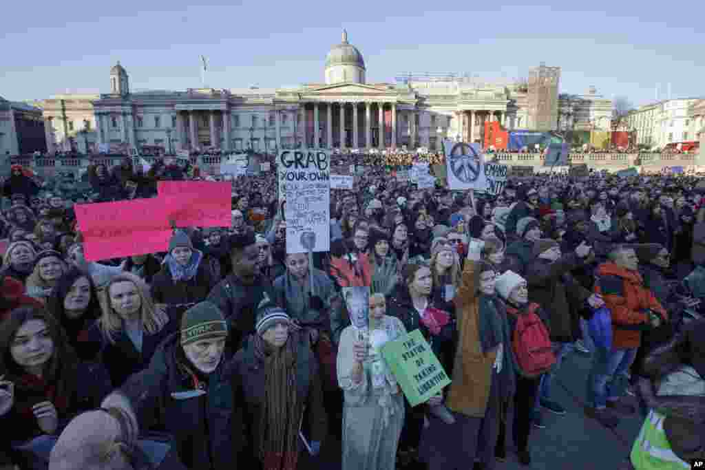 Demonstrators take part in the Women's March in Trafalgar Square, central London following the Inauguration of U.S. President Donald Trump in London, Saturday Jan. 21, 2016. The march is being held in solidarity with the Women's March in Washington, and other cities worldwide, advocating women's rights and opposing Donald Trump's U.S. presidency. National Gallery in background. (AP Photo/Tim Ireland)
