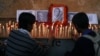 Indian students light candles to pay tribute to Ravi Shankar in Varanasi, where he was born in India, December 12, 2012. 