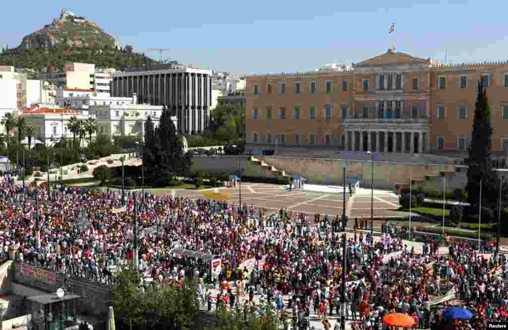 Supporters of the Greek Communist party march by the parliament during the strike in Athens Sept. 26, 2012. Flights and trains were suspended, shops pulled down their shutters and hospitals worked on emergency staff.