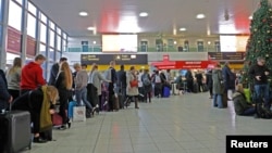 Passengers wait in the South Terminal building at Gatwick Airport after drones flying illegally over the airfield forced the closure of the airport, in Gatwick, Britain, Dec. 20, 2018. 