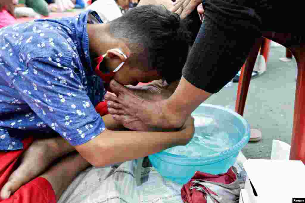 A child washes his mother's feet at an event to celebrate Indonesia's Mother's Day in Jakarta, Indonesia.