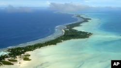 FILE - In this March 30, 2004, file photo, Tarawa atoll, Kiribati, is seen in an aerial view. Kiribati and several other small Pacific nations were among the last on the planet to have avoided any virus outbreaks, thanks to their remote locations and strict border controls.