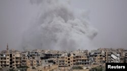 Smoke rises from Raqqa, Syria, July 28, 2017.