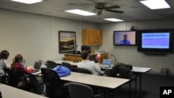 Medical students in the small town of Salina - population 50,000 - listen to a remote lecture. It's part of a Kansas University program designed to keep doctors in rural areas of the United States.