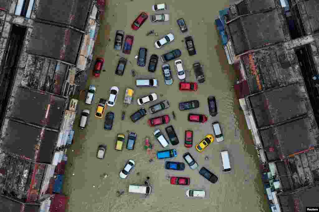 Vehicles and buildings are inundated by floods in Shah Alam's Taman Sri Muda, one of the worst hit neighborhoods in Selangor state, Malaysia.