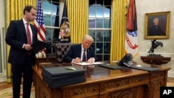 El presidente Donald Trump firma una orden ejecutiva que retira a Estados Unidos de la Organización Mundial de la Salud en la Oficina Oval de la Casa Blanca, el lunes 20 de enero de 2025, en Washington. AP