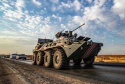 A Russian military police armored personnel carrier drives near the northeastern Syrian town of Amuda in Hasakah province, Oct. 24, 2019. Russian forces have started patrols along the frontier, filling the vacuum left by a U.S. troop exit.
