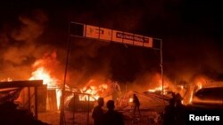 Fire rages following an Israeli strike on an area designated for displaced Palestinians, amid the ongoing conflict between Israel and Hamas, in Rafah in the southern Gaza Strip, in this still picture taken from a video, May 26, 2024.