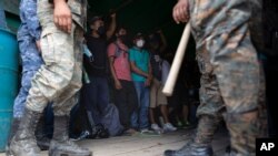 Honduras migrants stand in an army truck before returning home, in Morales, Guatemala, Oct. 3, 2020. 