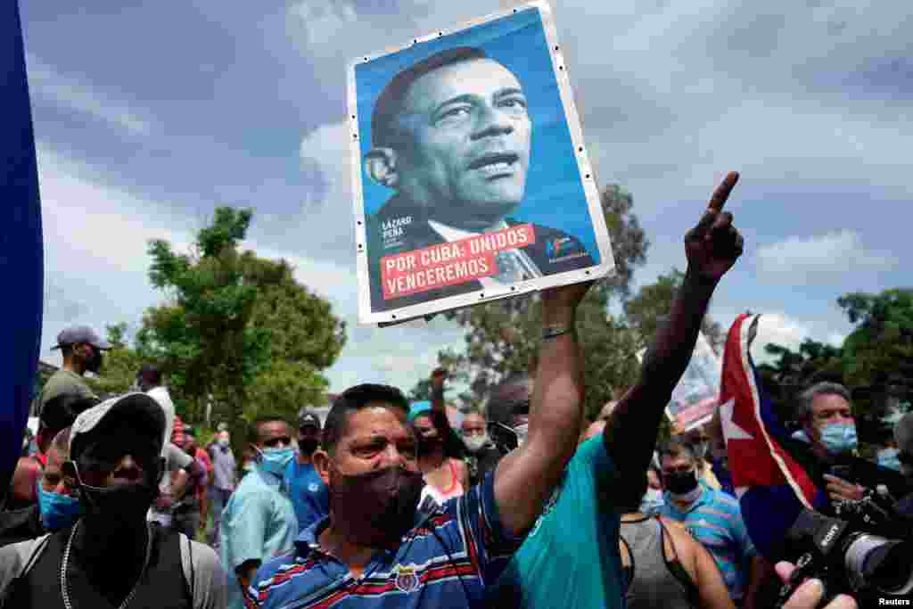 People shout slogans in support of the government as Cuba's President Miguel Diaz-Canel (not pictured) talks to the media, in San Antonio de los Banos, Cuba, July 11, 2021.