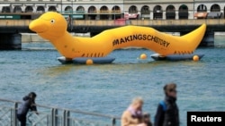 A giant 25m worm representing the parasitic worm of schistosomiasis is pictured on the Lake Leman on the occasion of the Neglected Tropical Diseases Summit, in Geneva, Apr, 18, 2017.
