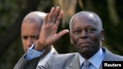 FILE - Angola's President Jose Eduardo dos Santos waves as he leaves Sao Bento Palace after a meeting with Portuguese Prime Minister Jose Socrates in Lisbon, March 11, 2009.