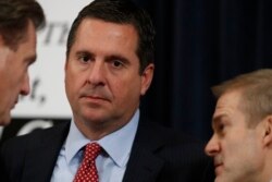Ranking member Rep. Devin Nunes, R-Calif., left, confers with Rep. Mike Turner, R-Ohio, left, and Rep. Jim Jordan, R-Ohio, during a break in the testimony before the House Intelligence Committee, Nov. 13, 2019, during its impeachment inquiry of President Donald Trump.