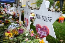 FILE - Flowers and other items are left as memorials outside the Tree of Life synagogue, Nov. 3, 2018, following a mass shooting there in Pittsburgh, Pa.