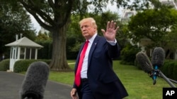 FILE - President Donald Trump departs after speaking with reporters on the South Lawn of the White House July 17, 2019, in Washington.