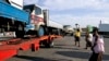 FILE - Trucks laden with goods headed for Zimbabwe are seen near the Beitbride border post between South Africa and Zimbabwe, in Musina, South Africa, March 28, 2008.