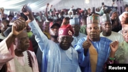 FILE - Bola Ahmed Tinubu reacts after he was declared winner in Nigeria's presidential election at his party's campaign headquarters, in Abuja, March 1, 2023.
