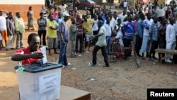 FILE - A man casts his vote at a polling station during presidential elections in Accra, Dec. 7, 2012.