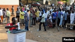 FILE - A man casts his vote at a polling station during presidential elections in Accra, Dec. 7, 2012. 