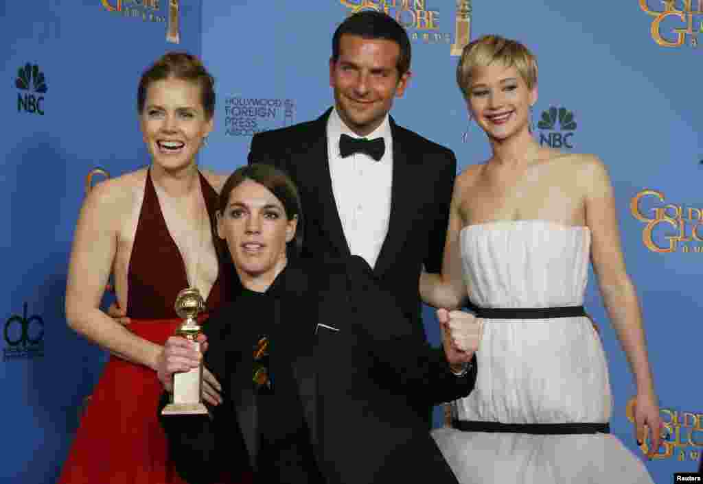 "American Hustle" stars Amy Adams, Bradley Cooper and Jennifer Lawrence pose with producer Megan Ellison after the film won the award for Best Motion Picture, Musical or Comedy at the Golden Globe Awards, Jan. 12, 2014.