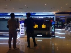 FILE - A shop in Hanoi sells electronics, which are becoming a big export product for Vietnam.