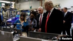 FILE - Donald Trump, president-elect at the time, tours a Carrier factory with vice president-elect Mike Pence in Indianapolis, Indiana, Dec. 1, 2016.