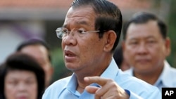 FILE - Cambodian Prime Minister Hun Sen speaks after his voting in a senate election at Takhmau polling station in Kandal province, southeast of Phnom Penh, Feb. 25, 2018. 