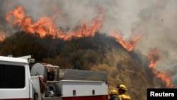 Firefighters battle the so-called Sand Fire in the Angeles National Forest near Los Angeles, California, July 25, 2016. 