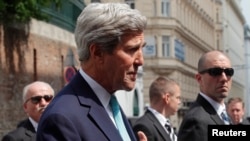 U.S. Secretary of State John Kerry talks to the media on his way to a meeting at a hotel in Vienna, July 13, 2014.