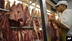  An employee works in a butcher shop in Brasilia, Brazil, Monday, March 20, 2017. 